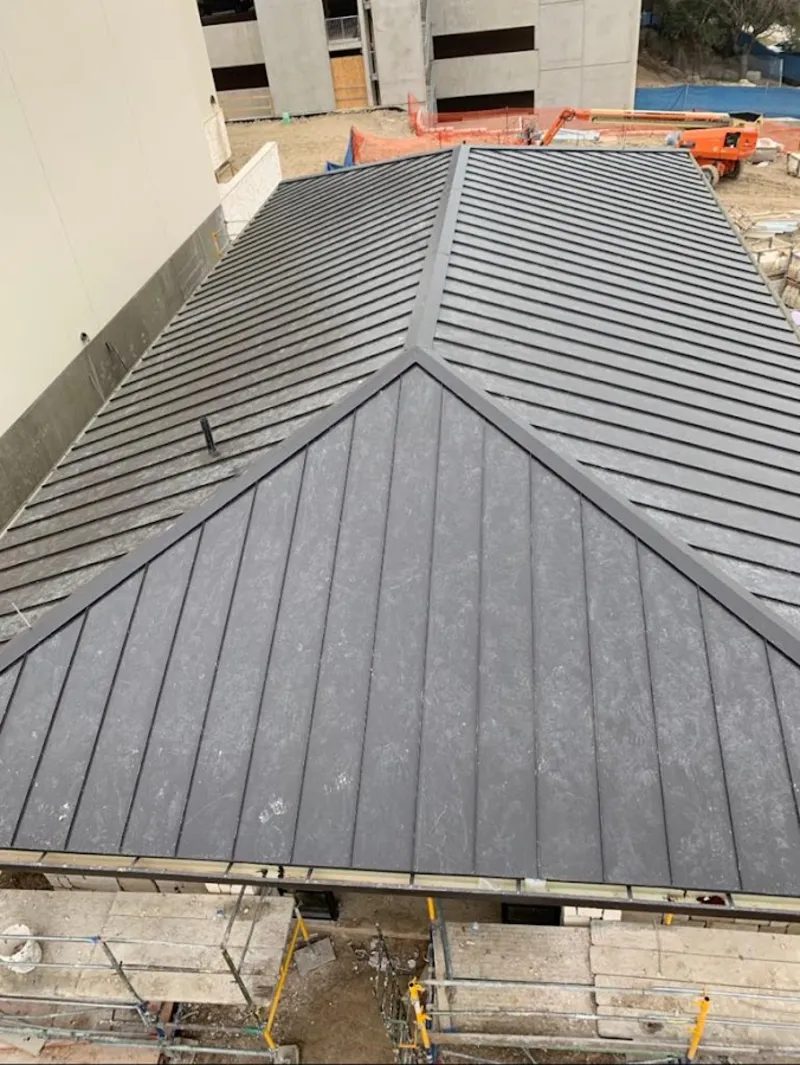 Commercial metal roof construction with crane equipment in Jesup