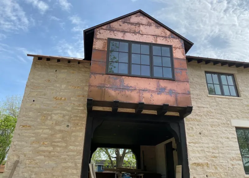 Copper metal panel facade on a stone building for Skylight Installation in Jesup
